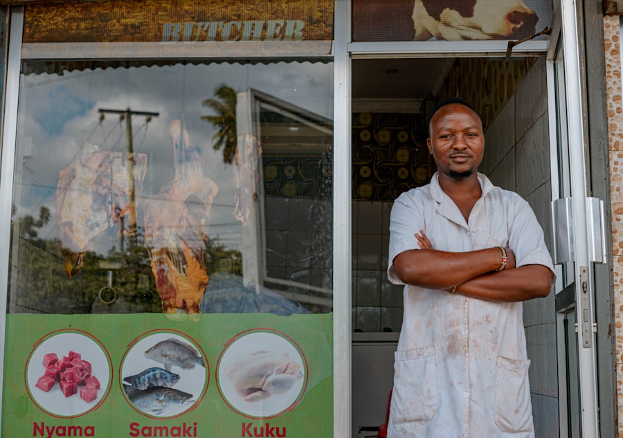Small business owner standing with arms crossed outside his shop in Charlotte, North Carolina